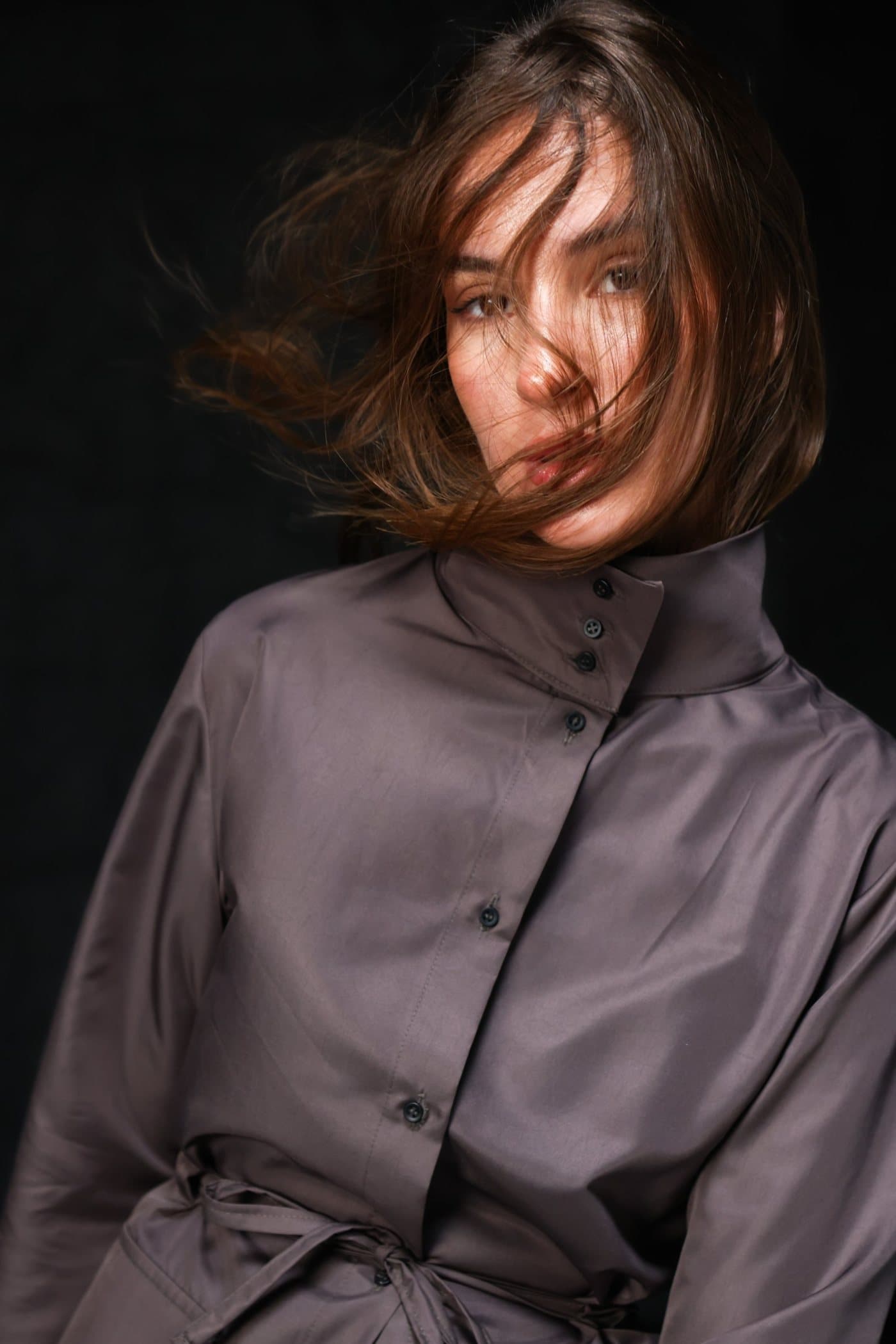 Close-up in the chocolate drawstring shirt jacket, hair in motion